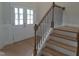 Inviting entryway with wood stairs and black iron railing, leading to the home's interior at 1042 Tulloch Court Ct # 213, Burlington, NC 27215