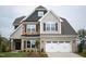 Charming two-story home featuring a brick facade, dark shutters, and a spacious two-car garage at 1042 Tulloch Court Ct # 213, Burlington, NC 27215