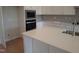 Bright kitchen featuring a large island with a sink, quartz countertops, and stainless steel appliances at 1042 Tulloch Court Ct # 213, Burlington, NC 27215
