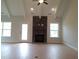 Inviting living room showcasing a stone fireplace, beamed ceiling, and natural light through large windows at 1042 Tulloch Court Ct # 213, Burlington, NC 27215