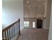 Open loft area overlooking the living room, with wood railings and a view of the stone fireplace at 1042 Tulloch Court Ct # 213, Burlington, NC 27215