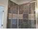 Modern tiled shower with glass doors, a built-in niche, and sleek fixtures for a luxurious experience at 1042 Tulloch Court Ct # 213, Burlington, NC 27215