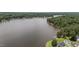 Scenic aerial view of a lakefront property surrounded by lush greenery and tranquil waters at 1051 Upland Reach, Sanford, NC 27332