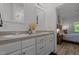 Bathroom features a dual sink vanity, framed mirror, and doorway leading to the bedroom at 1051 Upland Reach, Sanford, NC 27332