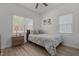 Bedroom with a floral patterned bed, bedside tables with lamps, and windows at 1051 Upland Reach, Sanford, NC 27332