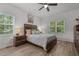 Bedroom features a window, ceiling fan, and bed with wood headboard and matching bedside tables at 1051 Upland Reach, Sanford, NC 27332