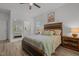 Bedroom features a window, ceiling fan, and bed with wood headboard and matching bedside tables at 1051 Upland Reach, Sanford, NC 27332