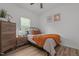 Cozy bedroom featuring neutral walls, wood floors, and natural light from the window at 1051 Upland Reach, Sanford, NC 27332