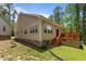 Exterior view of the home with a deck, vinyl siding, and well-maintained lawn at 1051 Upland Reach, Sanford, NC 27332