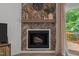Close-up of a fireplace with a wooden mantel and a decorative herringbone-patterned accent wall at 1051 Upland Reach, Sanford, NC 27332