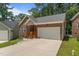 Beautiful brick townhome showcasing an attached garage, flower boxes, and a well-maintained front yard at 1051 Upland Reach, Sanford, NC 27332