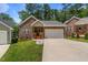 Beautiful brick home with a well-kept lawn and a spacious driveway leading to the garage at 1051 Upland Reach, Sanford, NC 27332