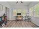 Bright home office with a ceiling fan, desk next to the window, and light wood grain flooring at 1051 Upland Reach, Sanford, NC 27332