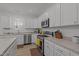 Well-lit kitchen features stainless appliances, white cabinets, and countertops at 1051 Upland Reach, Sanford, NC 27332