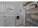 Functional laundry room with a washer and dryer, shelving, and natural light at 1051 Upland Reach, Sanford, NC 27332