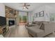 Cozy living room features a unique fireplace, wood floors, neutral tones, and sliding doors to the deck at 1051 Upland Reach, Sanford, NC 27332