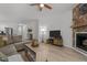 Spacious living room with hardwood floors, a sectional sofa, and a cozy fireplace at 1051 Upland Reach, Sanford, NC 27332