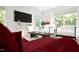 Sunlit living room with large windows, stylish furniture, and modern decor for comfortable living at 1053 Hardin Hill Ln, Knightdale, NC 27545