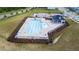 Aerial view of a community pool, lounge chairs and adjacent lawns at 1104 Briar Gate Dr, Holly Springs, NC 27540