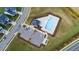 Aerial view of a community pool, parking and surrounding manicured lawns at 1104 Briar Gate Dr, Holly Springs, NC 27540