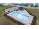 Aerial view of a community pool surrounded by lounge chairs and manicured landscaping at 1104 Briar Gate Dr, Holly Springs, NC 27540