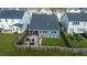 Aerial view of a fenced backyard with a patio seating area, and well-maintained lawn at 1104 Briar Gate Dr, Holly Springs, NC 27540