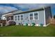 Backyard featuring a screened porch, lush lawn and flower pots at 1104 Briar Gate Dr, Holly Springs, NC 27540