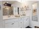 Bright bathroom featuring double sinks, vanity with gold accents, and a glass enclosed shower for spa-like experience at 1104 Briar Gate Dr, Holly Springs, NC 27540
