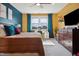 Cozy bedroom with a bed, a TV, and a vanity near the window at 1104 Briar Gate Dr, Holly Springs, NC 27540