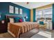 Bright bedroom featuring a queen bed with pillows, adjacent to a vanity under a window with natural light at 1104 Briar Gate Dr, Holly Springs, NC 27540