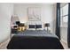 Chic bedroom with a queen bed, black and white accents, and decorative artwork creates a restful retreat at 1104 Briar Gate Dr, Holly Springs, NC 27540