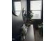 Stylish entryway with dark walls, decorative mirrors, plants and accent furniture by a bright window at 1104 Briar Gate Dr, Holly Springs, NC 27540