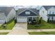 Aerial view of a home featuring a spacious front yard and a two car garage at 1104 Briar Gate Dr, Holly Springs, NC 27540