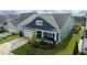 Inviting two-story home featuring a well-manicured lawn and charming front porch at 1104 Briar Gate Dr, Holly Springs, NC 27540