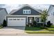 Beautiful home featuring a two-car garage, manicured lawn and professional landscaping at 1104 Briar Gate Dr, Holly Springs, NC 27540
