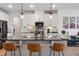 Modern kitchen featuring stone counters, a kitchen island, and stainless steel appliances at 1104 Briar Gate Dr, Holly Springs, NC 27540