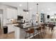 Modern kitchen featuring a kitchen island with counter seating, stainless appliances and hardwoods at 1104 Briar Gate Dr, Holly Springs, NC 27540