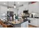 Modern kitchen features a kitchen island, granite countertops, and stainless steel appliances at 1104 Briar Gate Dr, Holly Springs, NC 27540