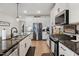 Spacious kitchen features granite countertops, stainless steel appliances, and hardwood floors at 1104 Briar Gate Dr, Holly Springs, NC 27540