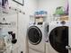 A functional laundry room with modern washer and dryer units, shelving, and ample storage space at 1104 Briar Gate Dr, Holly Springs, NC 27540
