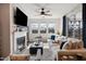Bright living room with a fireplace, comfortable seating, and natural light from large windows at 1104 Briar Gate Dr, Holly Springs, NC 27540