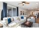 Open-concept living room with comfortable seating and sliding glass door to the outdoor space at 1104 Briar Gate Dr, Holly Springs, NC 27540