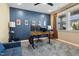Home office featuring a blue accent wall, natural light, and modern decor at 1104 Briar Gate Dr, Holly Springs, NC 27540