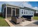 Cozy screened patio with comfortable seating for outdoor living and entertaining at 1104 Briar Gate Dr, Holly Springs, NC 27540