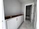 Bathroom featuring white cabinets and a door leading to the tub area at 111 Weavers Grv Dr, Chapel Hill, NC 27514