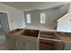 Kitchen under construction with white cabinets and a view to the living area and stairway at 111 Weavers Grv Dr, Chapel Hill, NC 27514