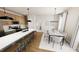 Well-lit kitchen and dining area with breakfast bar, modern appliances, and stylish dining set at 111 Weavers Grv Dr, Chapel Hill, NC 27514
