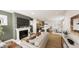 Open-concept living space with fireplace, sleek furniture, adjacent kitchen, and a dining area at 111 Weavers Grv Dr, Chapel Hill, NC 27514
