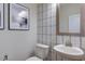 A charming powder room showcasing stylish wallpaper, a modern vanity, and elegant fixtures at 113 Seagraves Creek Ln, Holly Springs, NC 27540