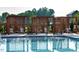Serene community pool featuring lounge chairs and relaxing cabanas for leisure and shade at 113 Seagraves Creek Ln, Holly Springs, NC 27540